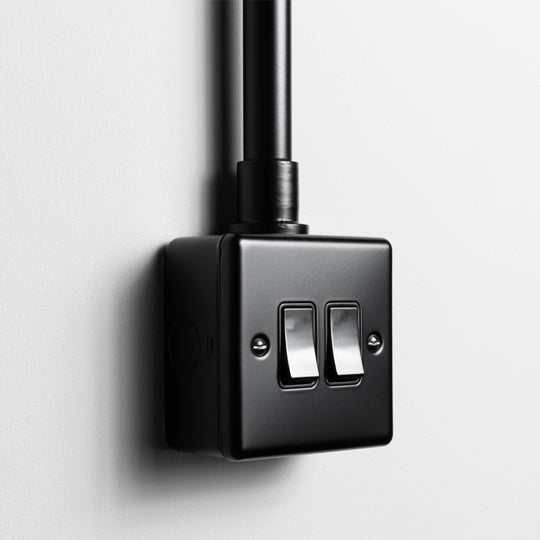 Matt Black 2 Gang 2 Way Switch Wirth Back Box And Conduit On A Light Grey Background