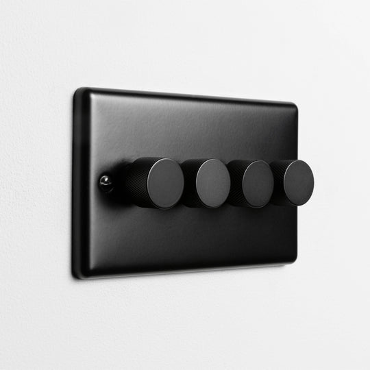 Matt Black 4 Gang LED Dimmer Switch On A Light Grey Background