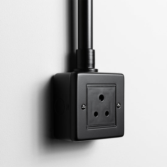 Matt Black 5A Socket With A Back Box And Conduit On A Light Grey Background