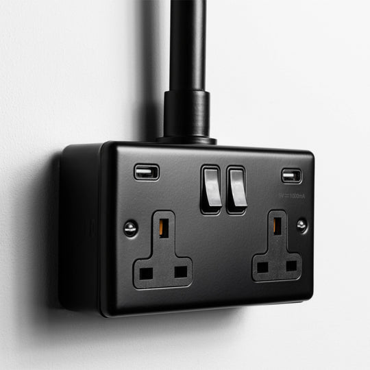 Matt Black Double Socket With Twin USB A With Back Box And Conduit On A Light Grey Background