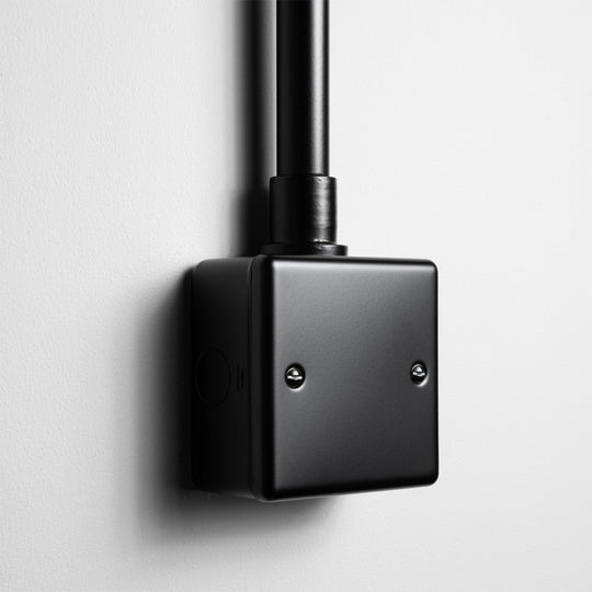 Matt Black Single Blank Plate With A Back Box And Conduit On A Light Grey Background