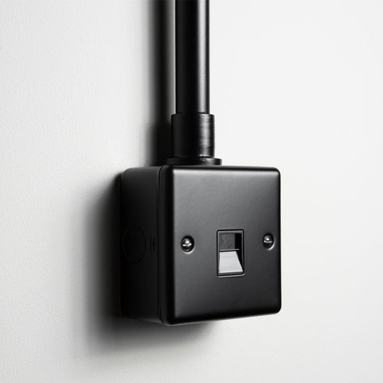 Matt Black Telephone Socket With Back Box And Conduit On A Light Grey Background