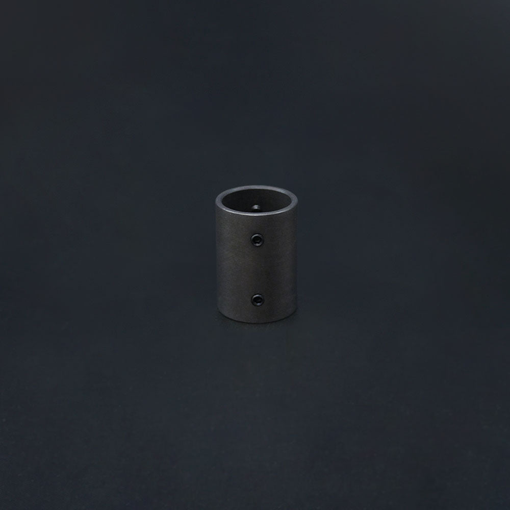 A dark bronze 20mm conduit coupler with grub screws on a dark background.