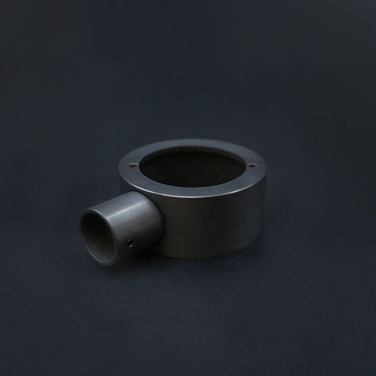 A dark bronze end box for conduit, displayed on a dark background.