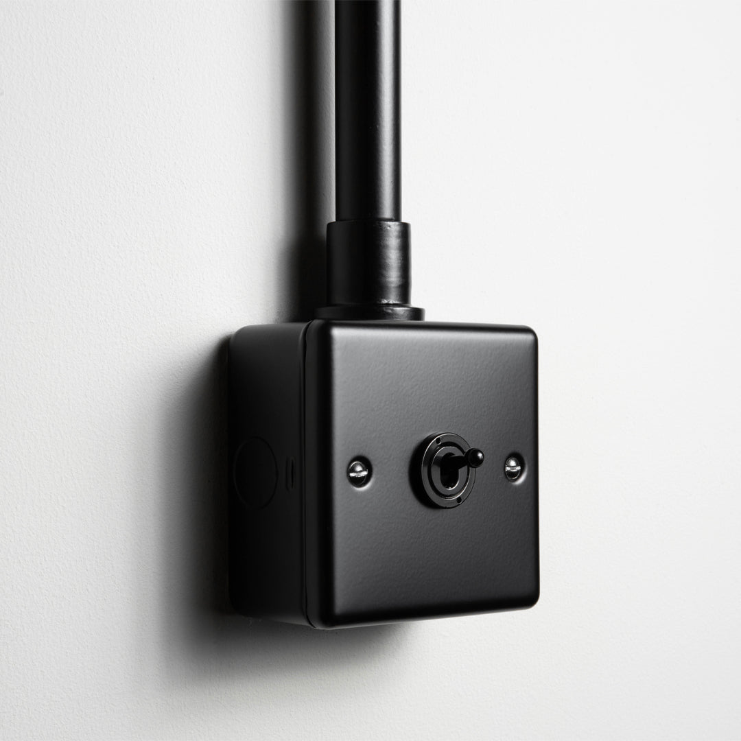 Matt Black 1 Gang 2 Way Toggle Switch With Back Box And Conduit On Light Grey Background