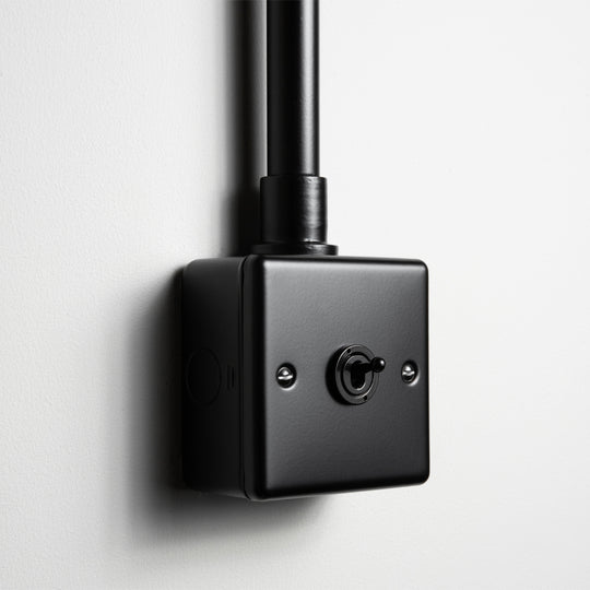 Matt Black 1 Gang 2 Way Toggle Switch With Back Box And Conduit On Light Grey Background