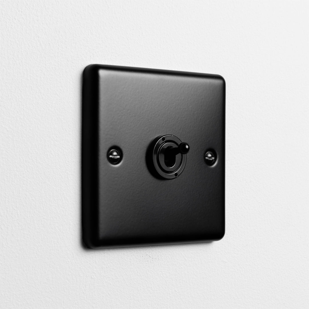 Matt Black Intermediate Toggle Switch On Light Grey Background