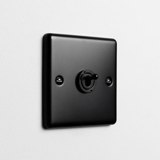 Matt Black 1 Gang 2 Way Toggle Switch On Light Grey Background