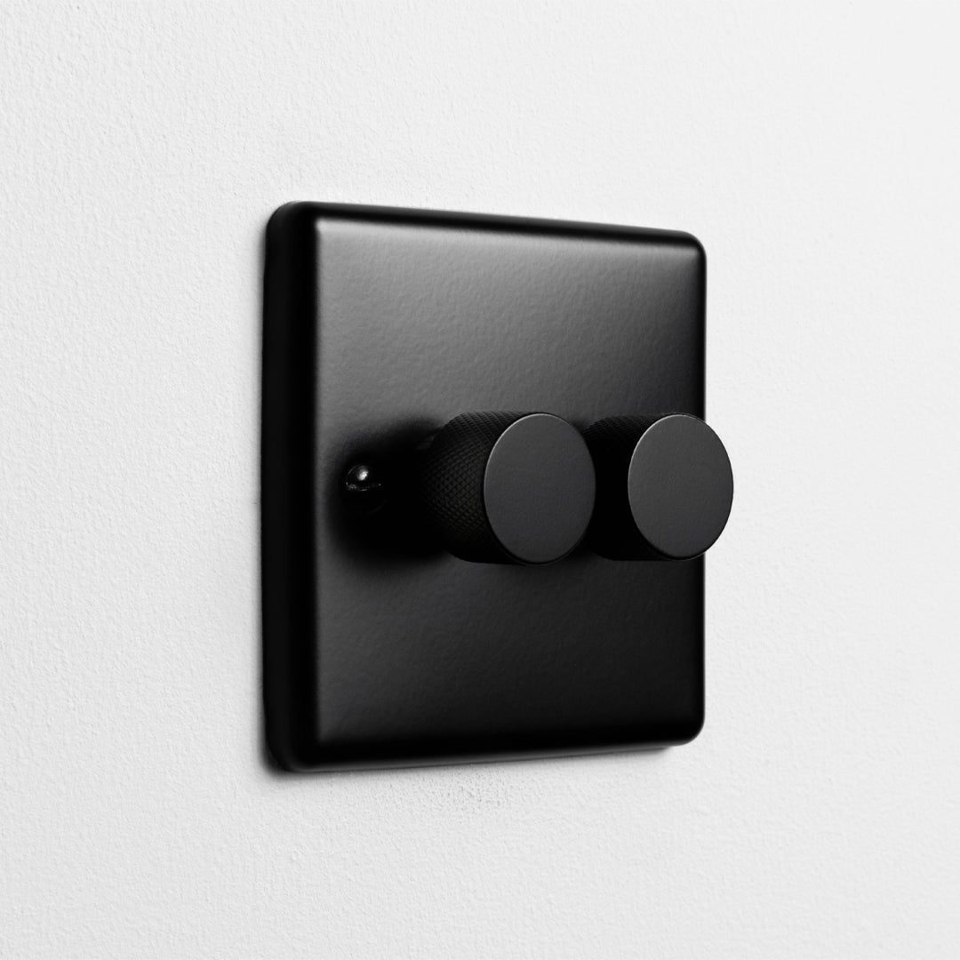 Matt Black 2 Gang 2 Way LED Dimmer Switch On A Light Grey Background