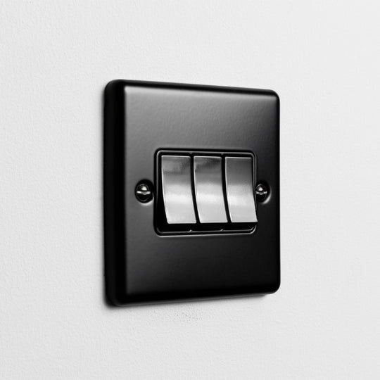 Matt Black 3 Gang 2 Way Switch On A Light Grey Background