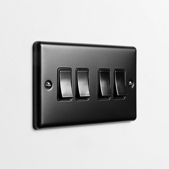 Matt Black 4 Gang 2 Way Switch On A Light Grey Background