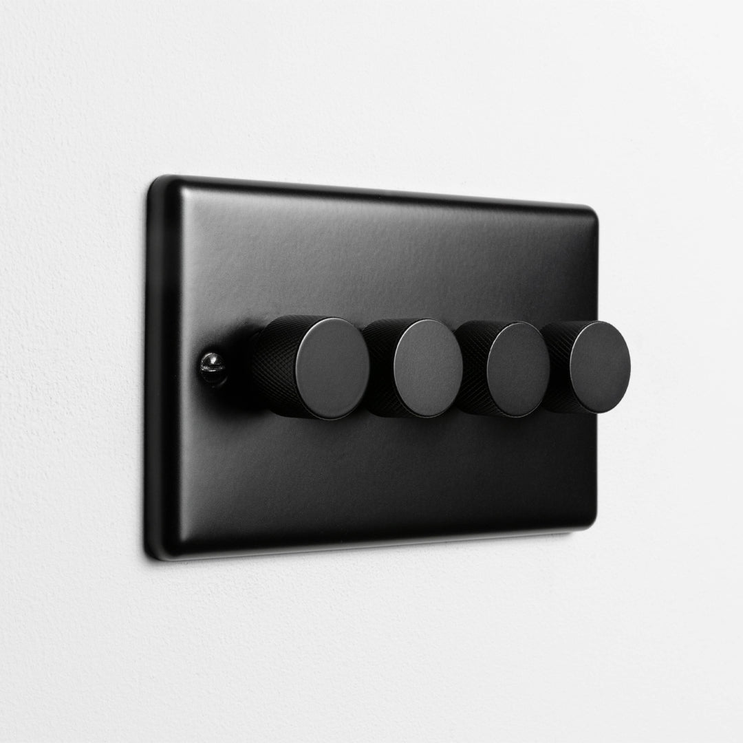 Matt Black 4 Gang LED Dimmer Switch On A Light Grey Background