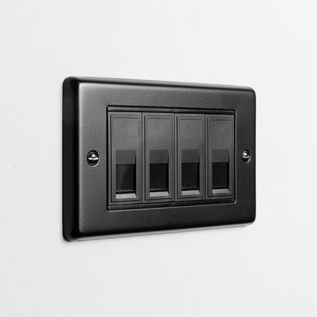 Matt Black 4 Gang RJ45 Socket On A Light Grey Background