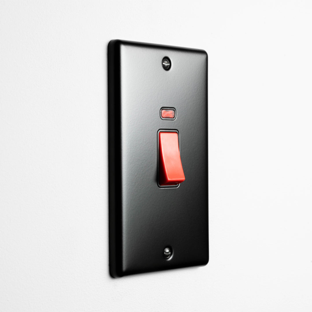Matt Black 2 gang 45A Double Pole Switch On A Light Grey Background