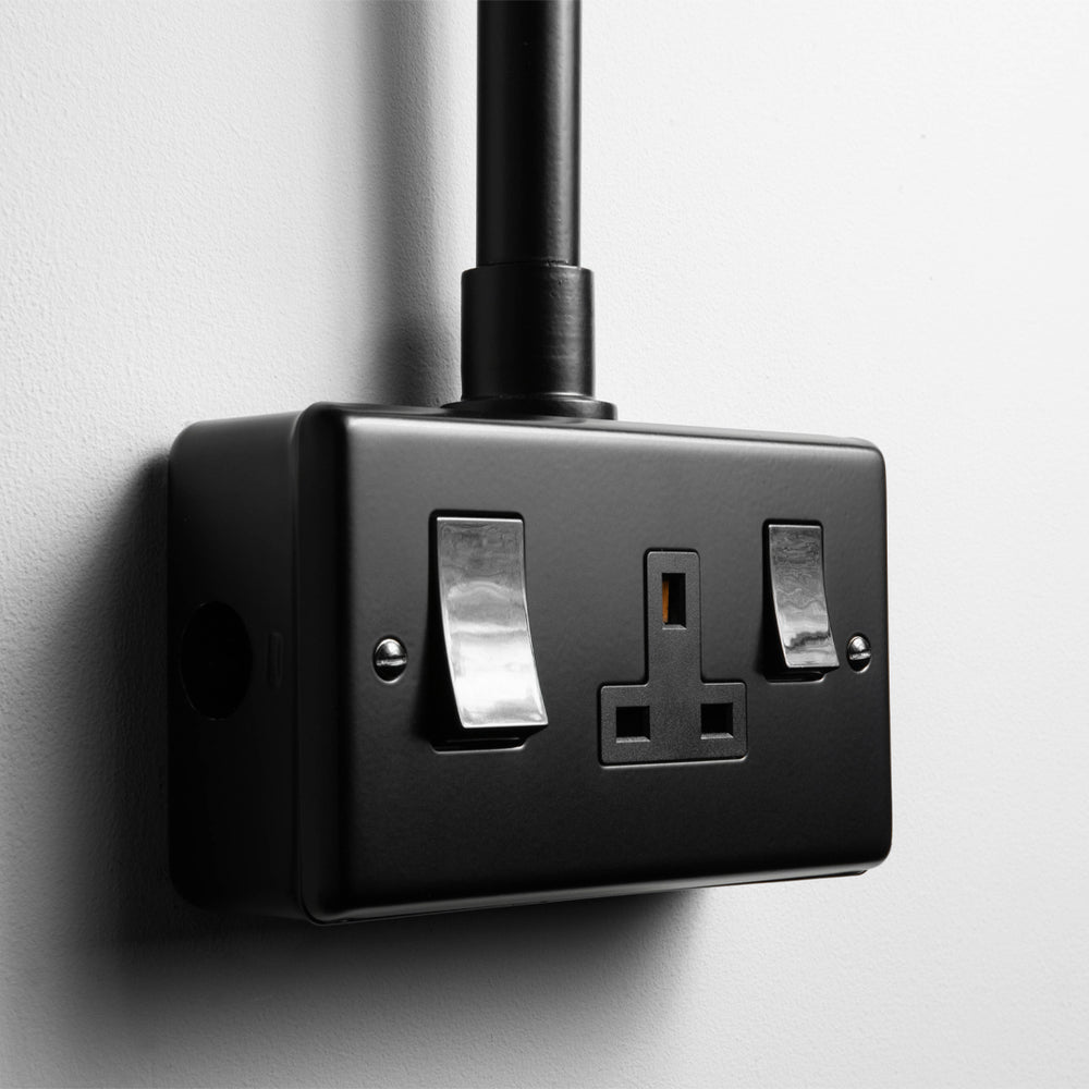 Matt Black 45A Cooker Switch with Socket With Back Box And Conduit On A Light Grey Background